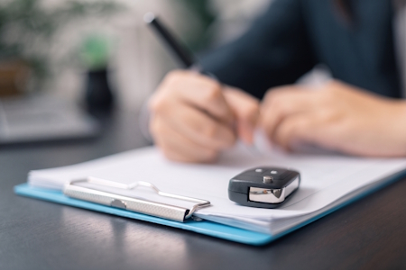 A donor completing car donation paperwork